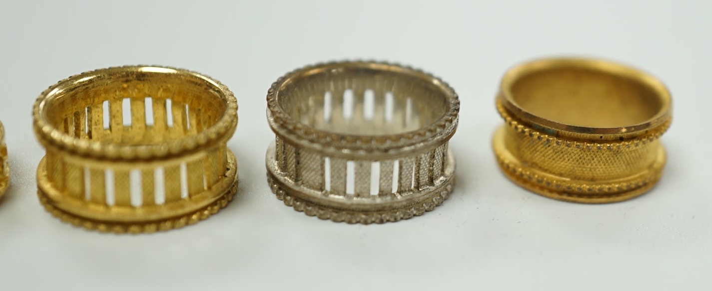 A rare Regency morocco leather mounted white metal cylindrical ring box containing five pinchbeck/base metal sample rings, box length 47mm.
